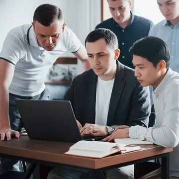 Web design team working together on a laptop